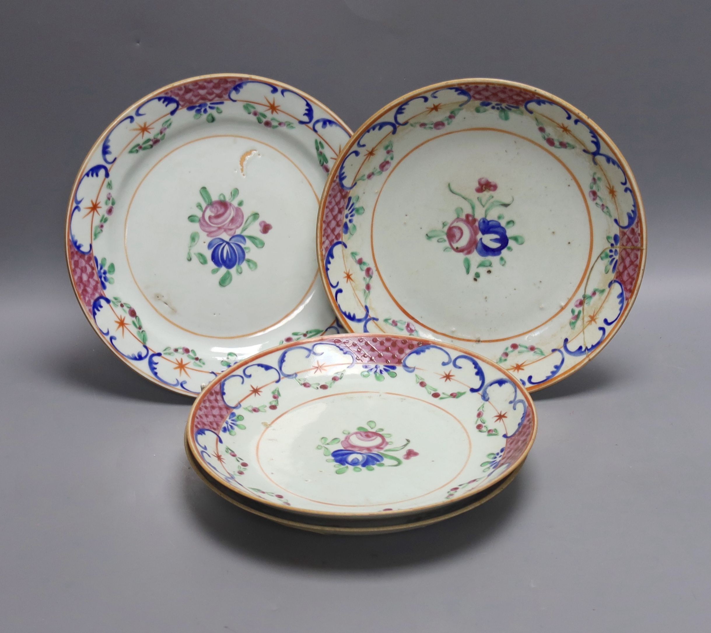 Three early 19th century Chinese polychrome-decorated shallow dishes and a matching plate (one repaired), Dia 22cm